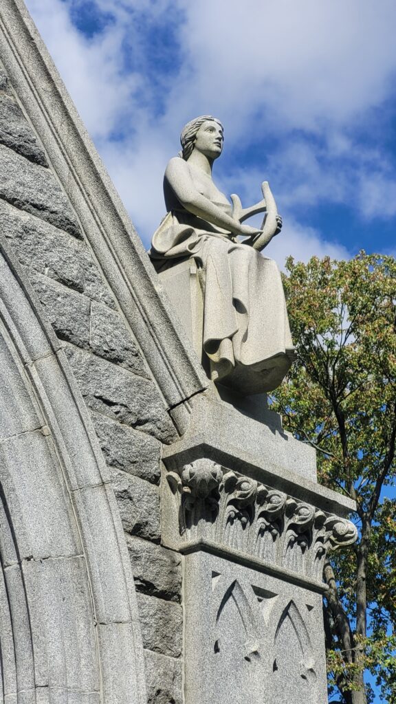 Carved granite sculpture representing Music.