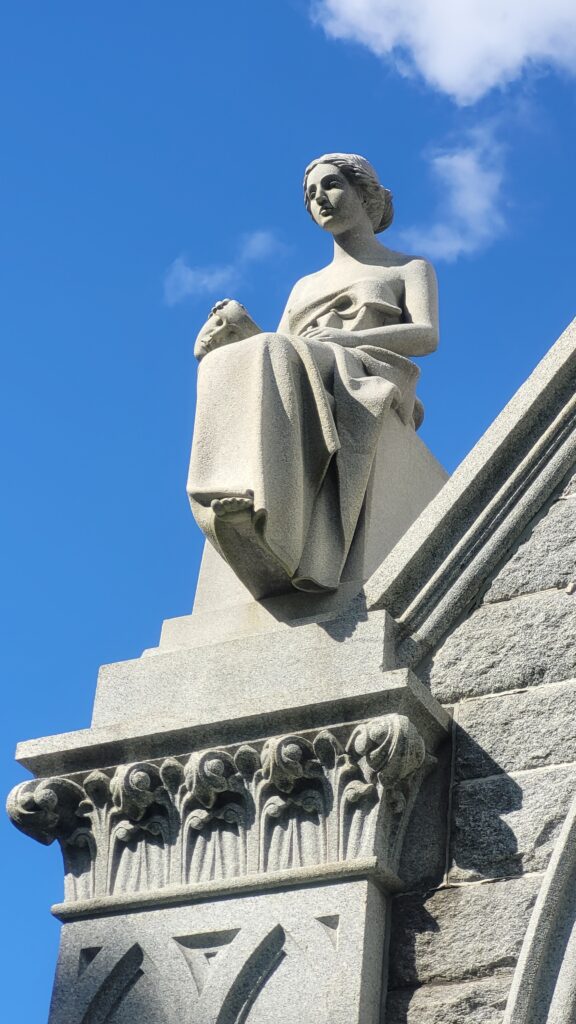 Carved granite sculpture representing Drama.