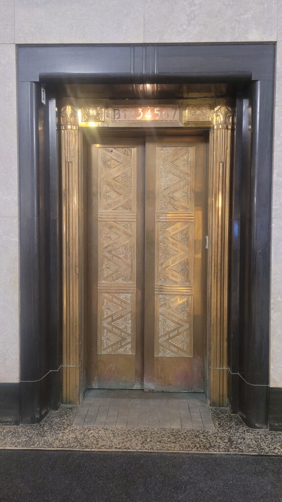 Ornamental bronze and brass fixtures adorn interior doors.