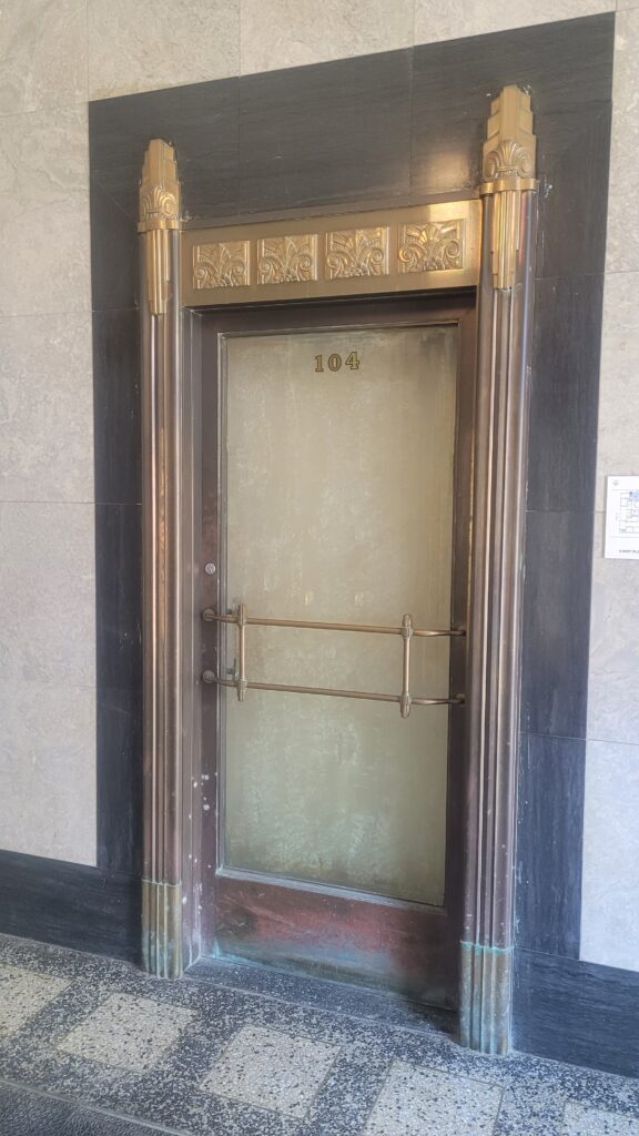 Ornamental bronze and brass fixtures adorn interior doors.