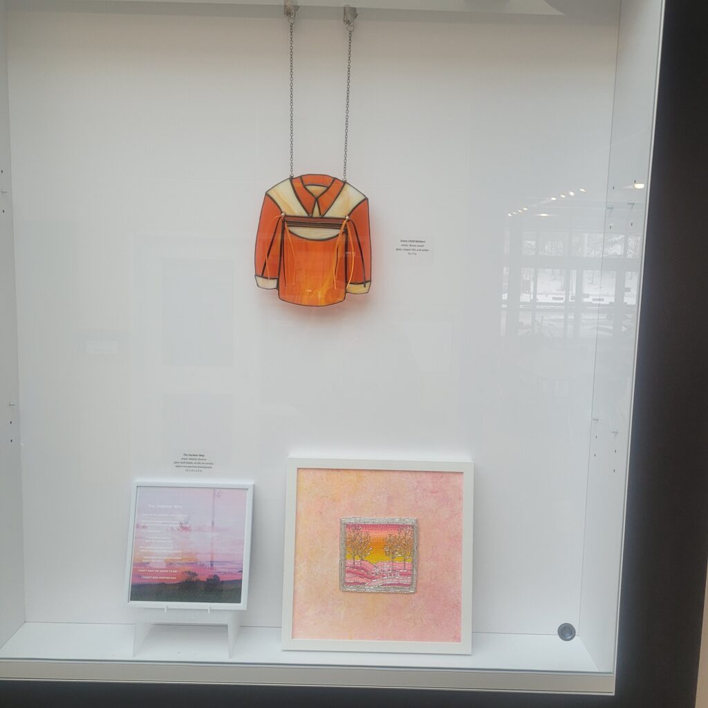 Grouping of Indigenous Art in display case.