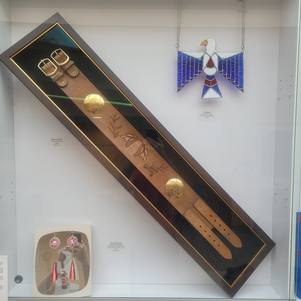 Grouping of Indigenous Art in display case.