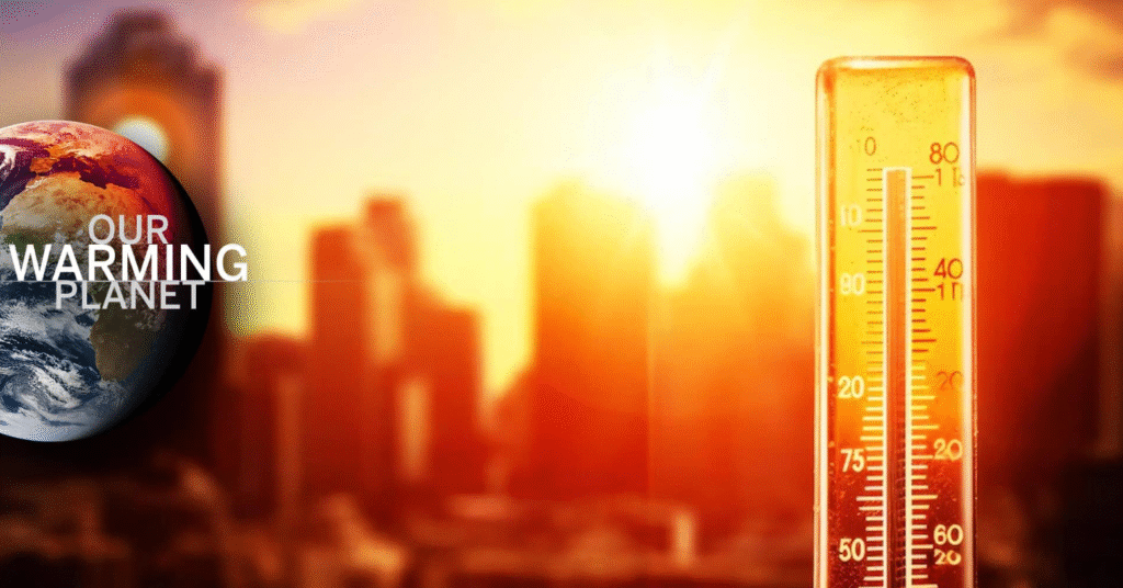 Shimmering city view with thermometer in foreground showing scorching high temperature.