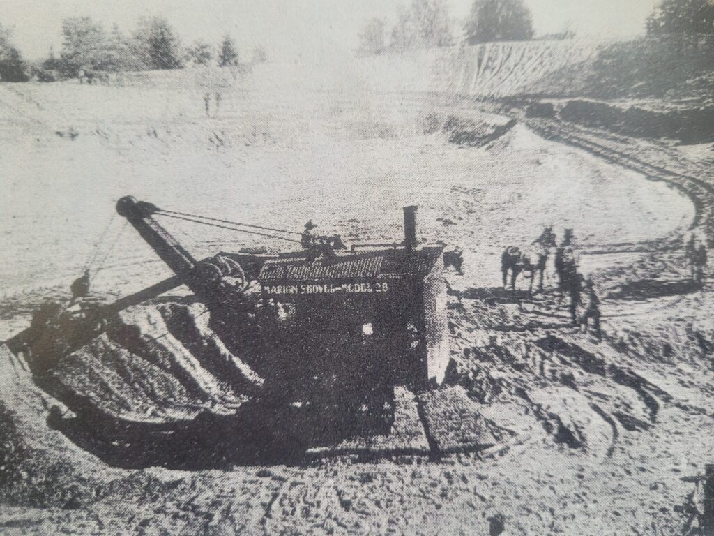 Large excavator digging out the reservoir.