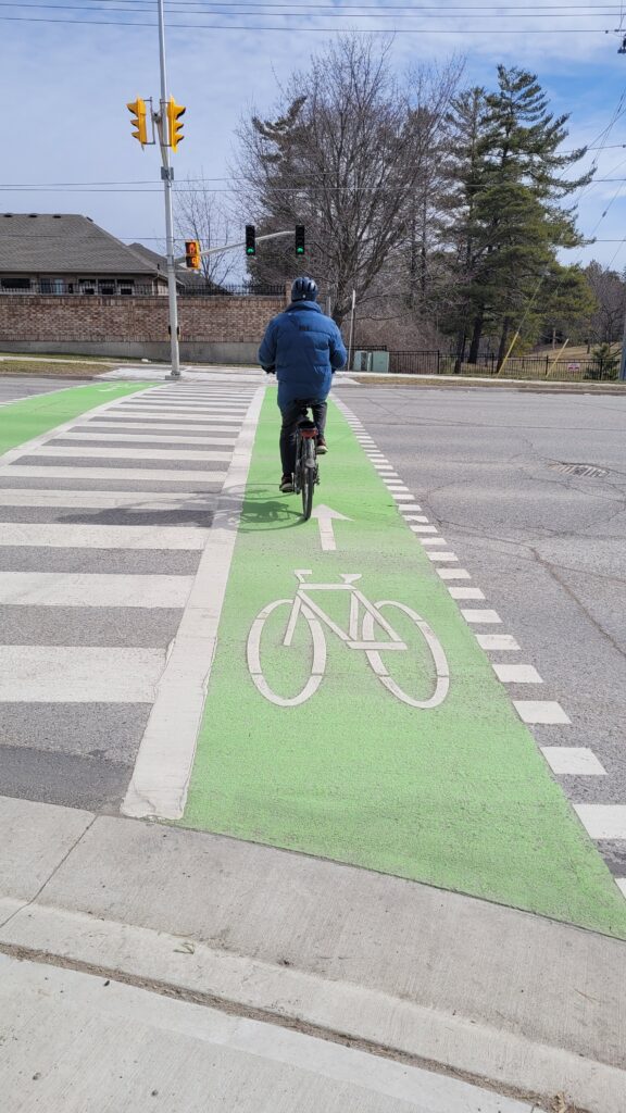 Person on a bicycle crossing the street at a crossride.