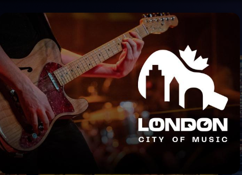 Guitar player in background, London, City of Music, in the foreground.