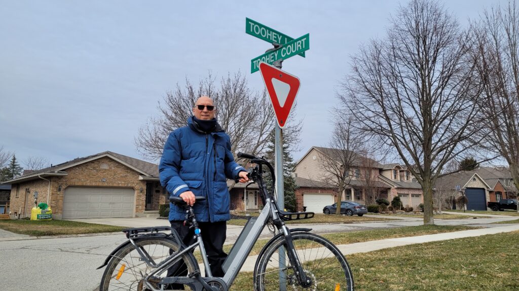 Author in front of Toohey Lane sign.