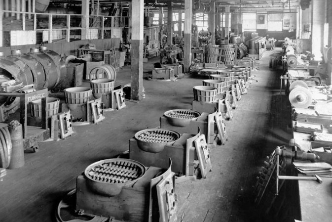 Line of cast iron stoves being made in a McClary factory.