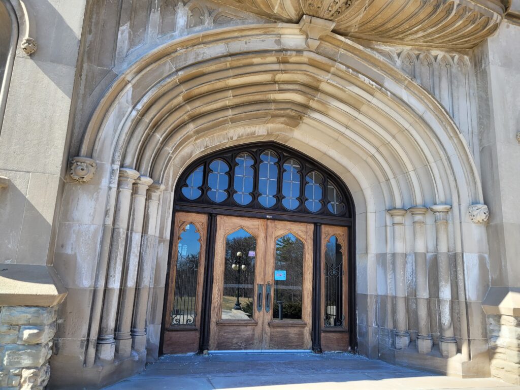 Notice the pointed arches, massive presence, and detailed stone work at the entrance to University College, built in 1922.