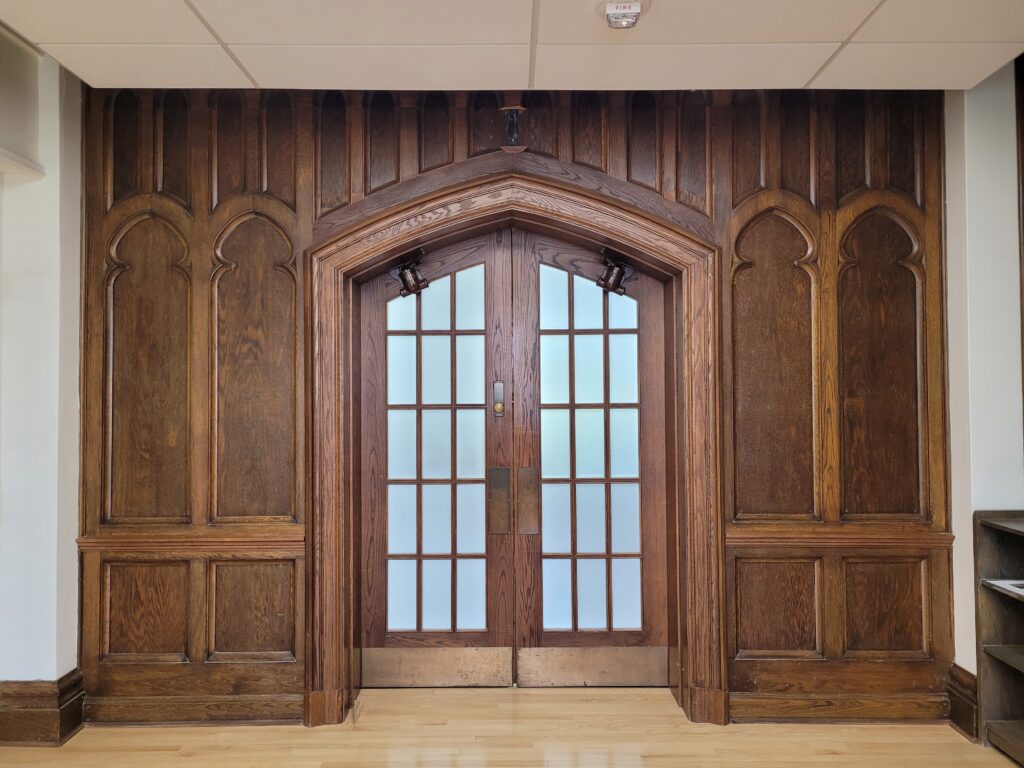 Heavy oak doors leading into Conron Hall.