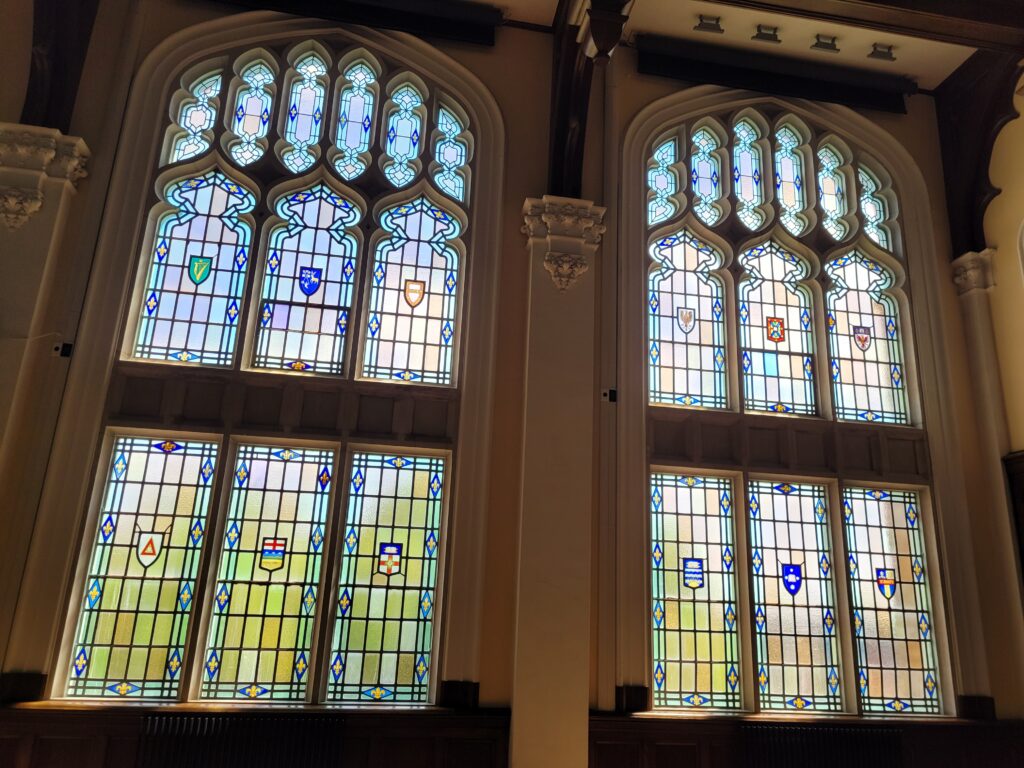 Close-up of heraldic shields on stained glass windows.
