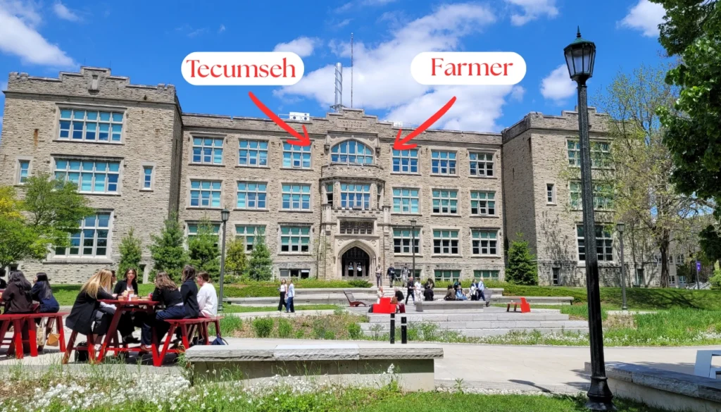 The Physics and Astronomy Building, with arrows pointing to the tiny Tecumseh and Yorkshire Farmer carvings.