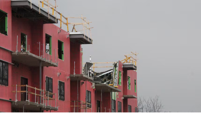 Top floor of a partially collapsed apartment building.