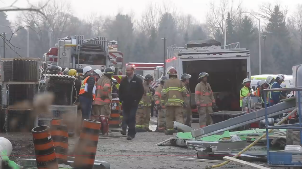 Emergency workers on the scene. of a building collapse.