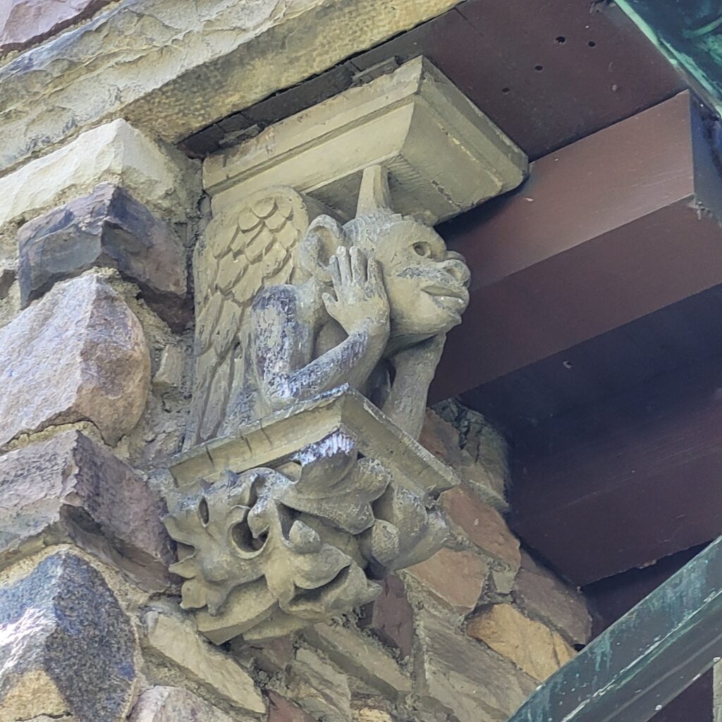 One gargoyle under the eave.