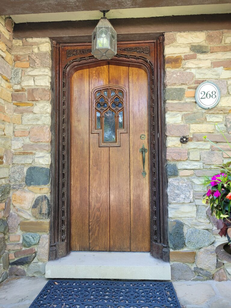 Solid oak front door with hand-carved wooden door frame.