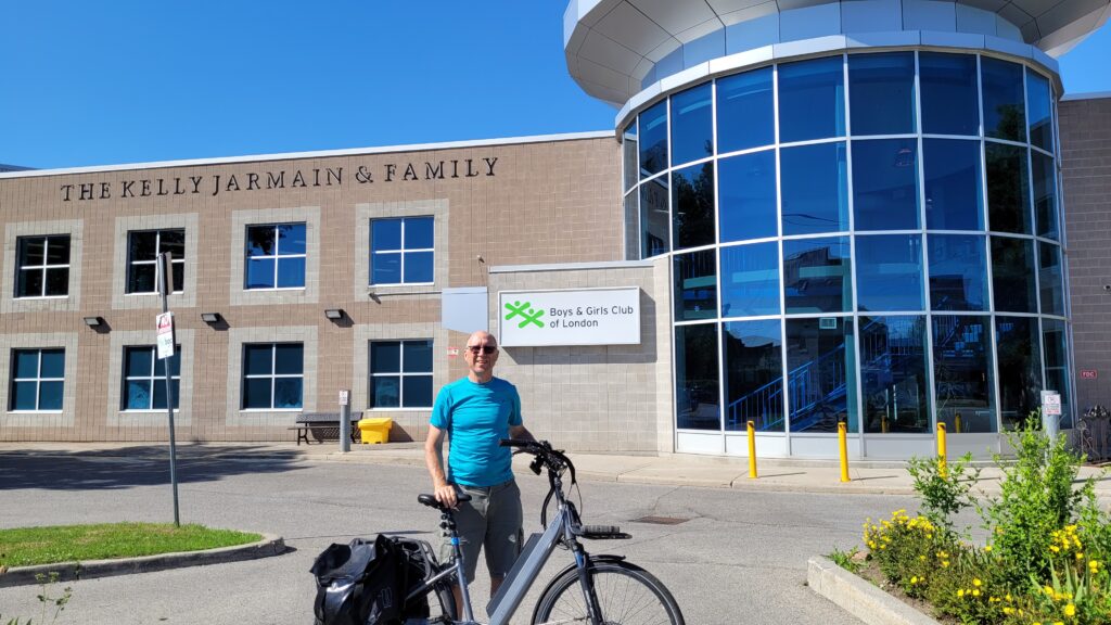 The author, in front of the Boys and Girls Club of London with his bicycle.