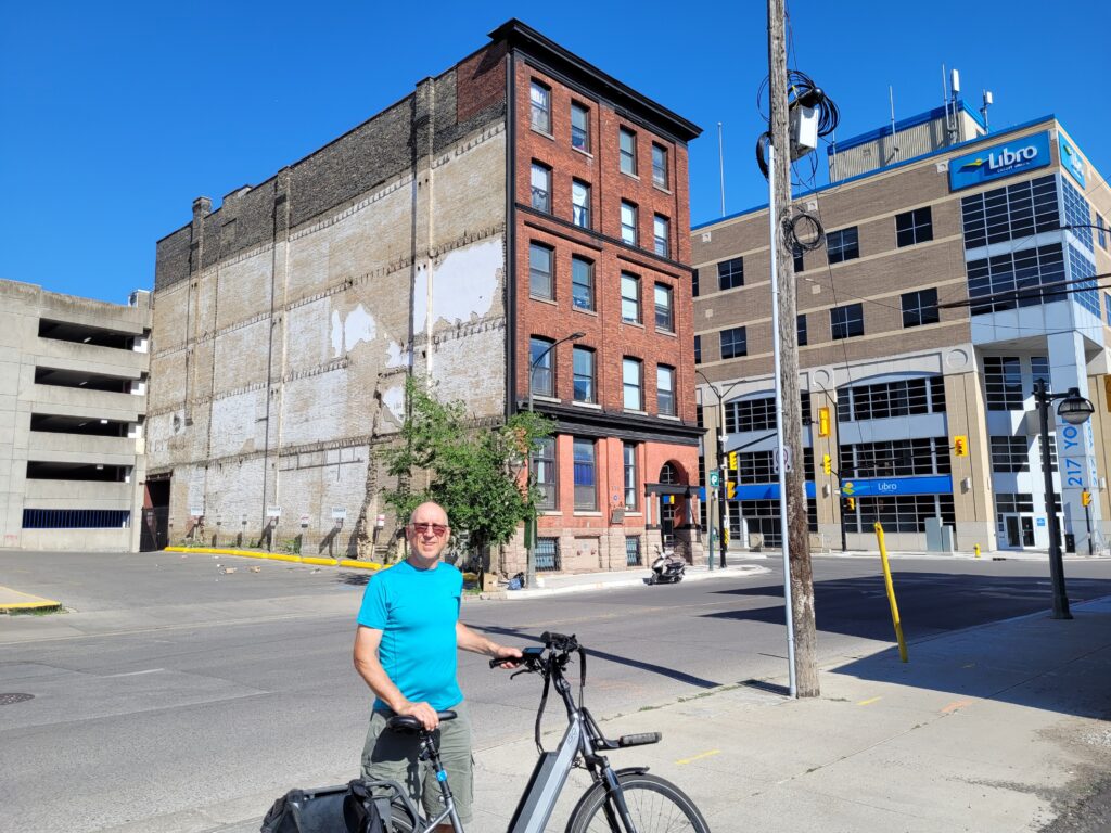 The author, standing with his bicycle in front of Sterling Place, at the corner of York and Clarence Streets.