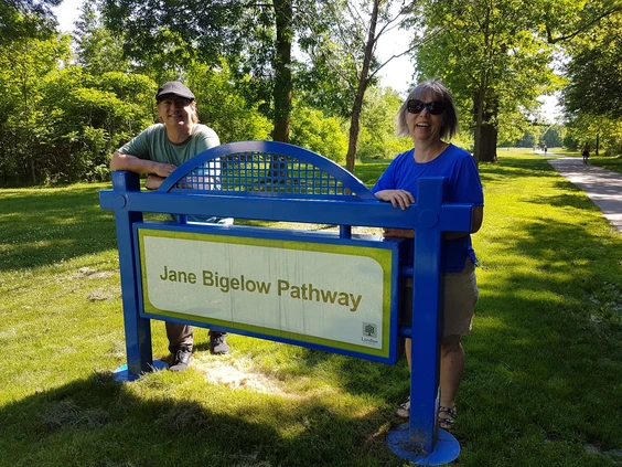 David and Ann Bigelow, adult children of London's first female mayor, Jane Bigelow, stand at the entrance to the trail that bears their mother's name. 