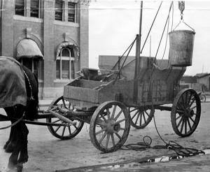 Horse-drawn honey wagon with rope and pulleys used to load buckets onto the wagon.