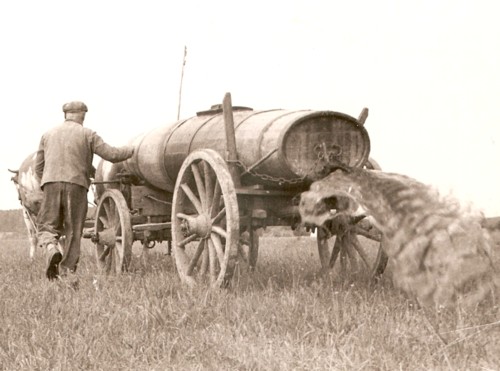 Farmer using a honey wagon to spread spreading human feces on a field.