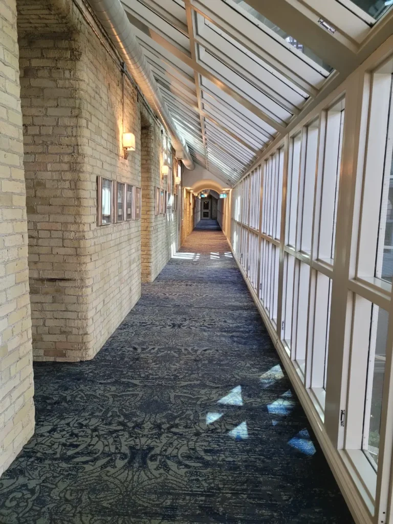 The second-floor corridor with abundant light streaming in from above.
