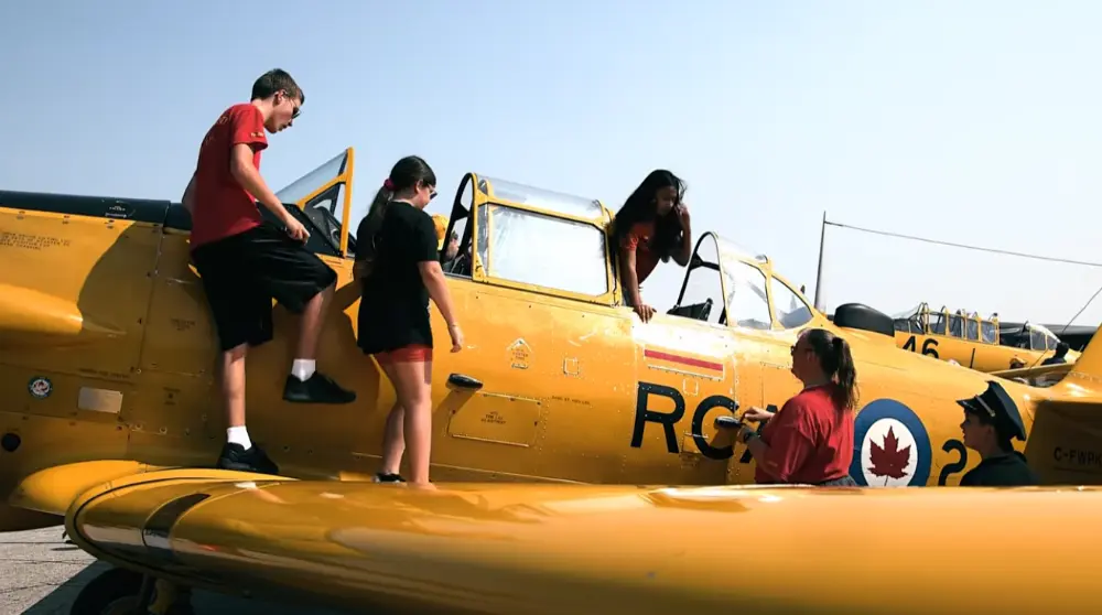Families exploring planes up close, including climbing into the cockpit.