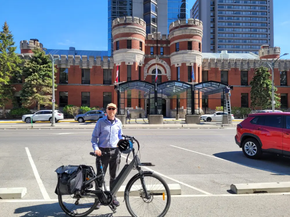 The author, standing with his bicycle across the street from the hotel.