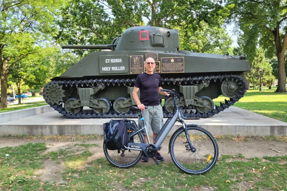 Author Lawrence Durham standing in front of the Holy Roller in Victoria Park.