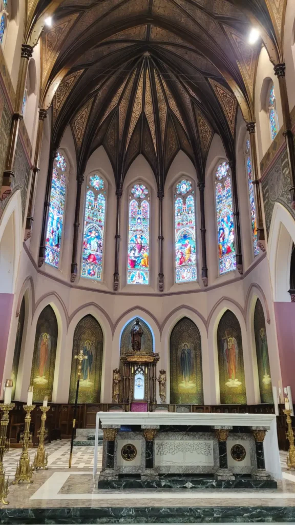 A view of the altar and stained glass windows.