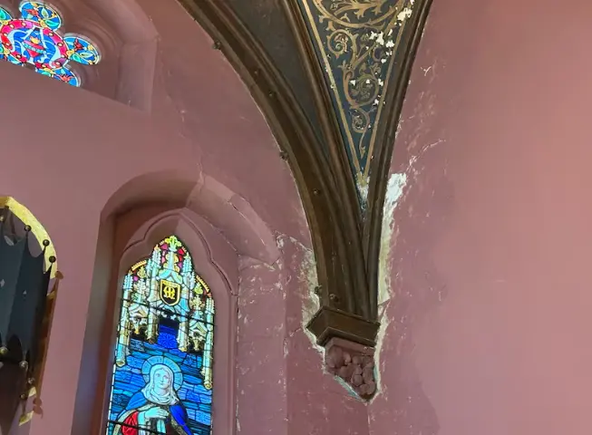 Significant water damage is visible on the ceilings and columns.