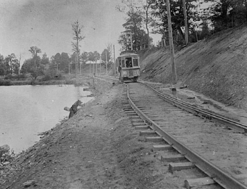 A streetcar on the Springbank line, passing by Woodland Cemetery on the right and the Thames River on the left.