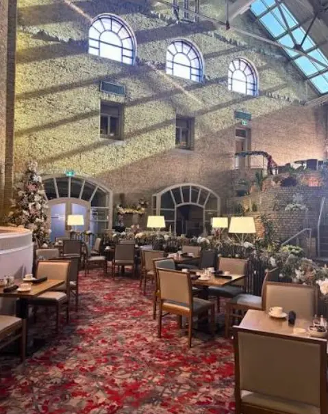 Below the Cantata Lounge is the Armouries Grille, showing the sunlit atrium and dining area.