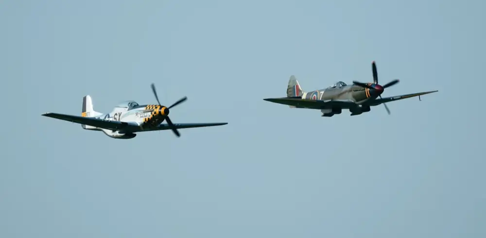 Two vintage aircraft flying by.