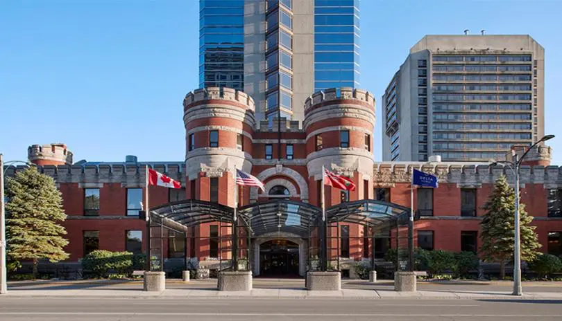 View of the main hotel entrance with glass towers behind. 
