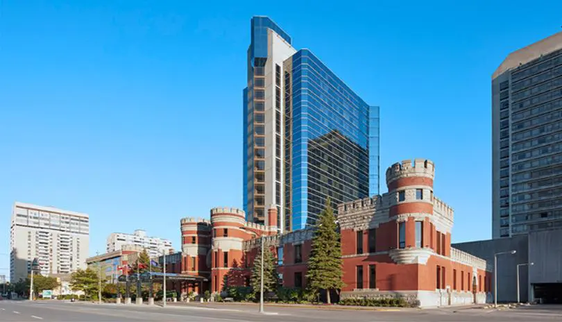 Corner view of the hotel, looking southeast, showing multiple towers behind it.